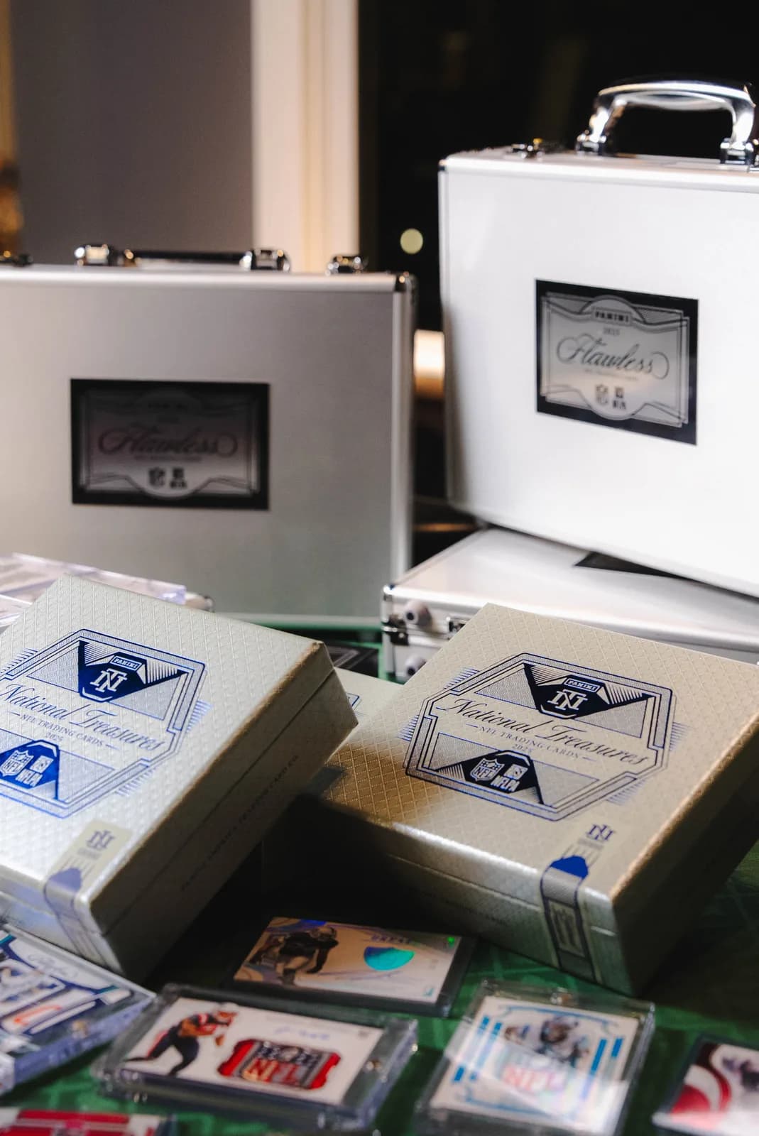 Custom silver collector cases surrounded by premium football cards